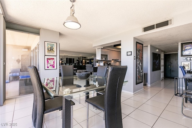 3111 Bel Air Dr Unit 9E, Las Vegas, NV 89109 - dining area with a textured ceiling and light tile patterned floors