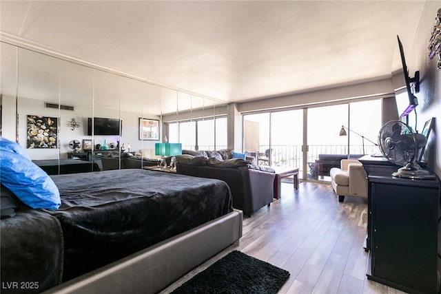 3111 Bel Air Dr Unit 9E, Las Vegas, NV 89109 - bedroom featuring wood finished floors and multiple windows