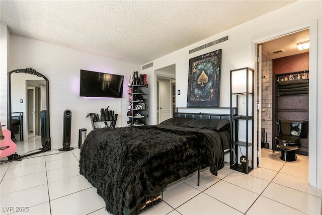 3111 Bel Air Dr Unit 9E, Las Vegas, NV 89109 - bedroom with light tile patterned flooring and a textured ceiling