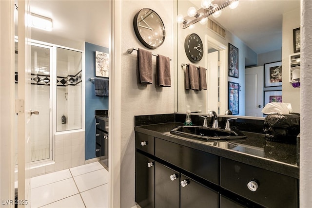 3111 Bel Air Dr Unit 9E, Las Vegas, NV 89109 - bathroom featuring tiled shower, vanity, and tile patterned flooring