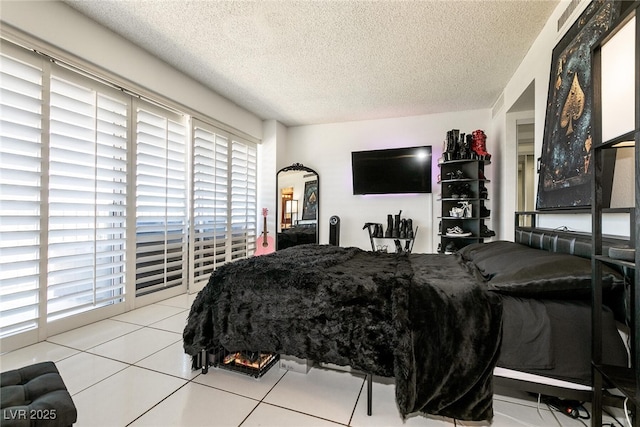 3111 Bel Air Dr Unit 9E, Las Vegas, NV 89109 - bedroom with multiple windows, a textured ceiling, and tile patterned flooring