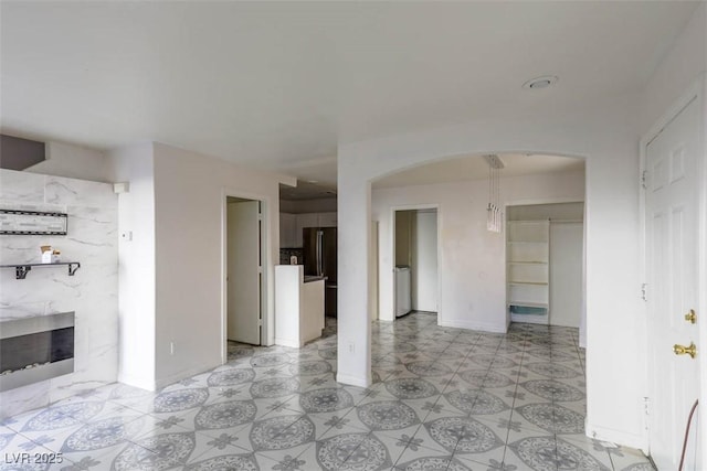 3336 Cheyenne Gardens Way N, Las Vegas, NV 89032 - unfurnished room with arched walkways and a premium fireplace
