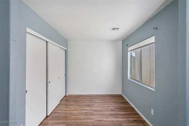 3336 Cheyenne Gardens Way N, Las Vegas, NV 89032 - unfurnished bedroom with wood finished floors and a closet