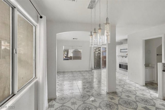 3336 Cheyenne Gardens Way N, Las Vegas, NV 89032 - hallway with arched walkways and light tile patterned floors