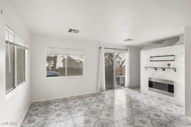 3336 Cheyenne Gardens Way N, Las Vegas, NV 89032 - unfurnished living room featuring a high end fireplace and baseboards
