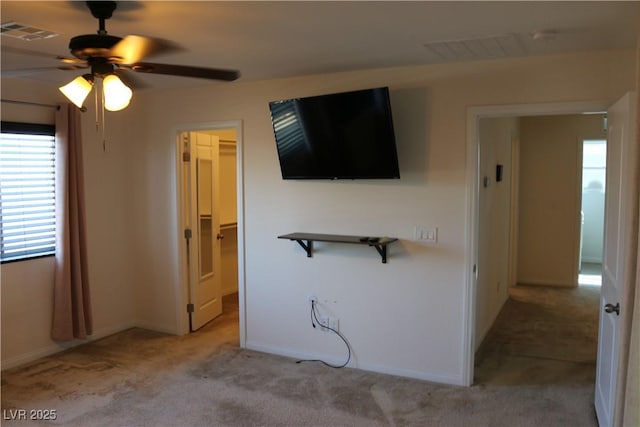 2102 Stone Well Rd, North Las Vegas, NV 89031 - unfurnished bedroom featuring light colored carpet, a walk in closet, and ceiling fan