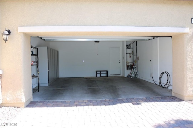 2102 Stone Well Rd, North Las Vegas, NV 89031 - garage with strapped water heater and driveway
