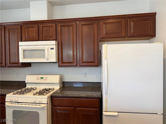 5905 Addy Ln, North Las Vegas, NV 89081 - kitchen with white appliances and dark countertops