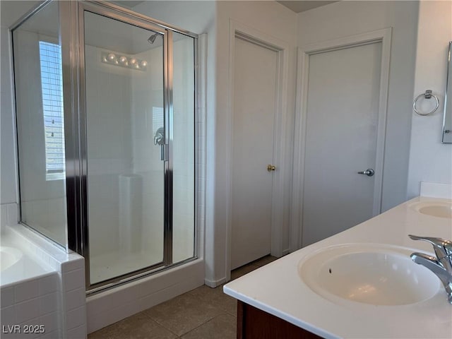 5905 Addy Ln, North Las Vegas, NV 89081 - full bathroom featuring a stall shower, a bath, double vanity, and tile patterned floors