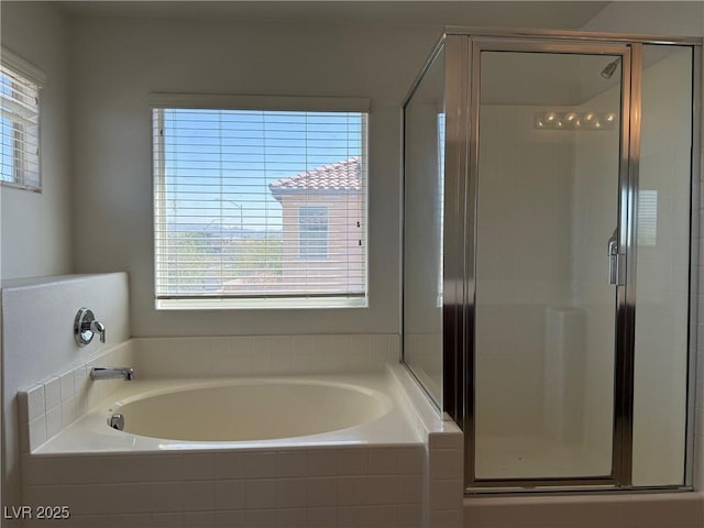 5905 Addy Ln, North Las Vegas, NV 89081 - bathroom with plenty of natural light, a garden tub, and a shower stall