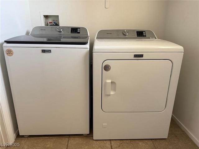 5905 Addy Ln, North Las Vegas, NV 89081 - laundry room with washer and dryer and light tile patterned flooring