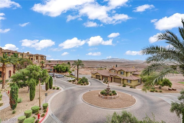 15 Via Mantova Unit 208, Henderson, NV 89011 - view of asphalt road with a residential view, curbs, sidewalks, and a mountain view