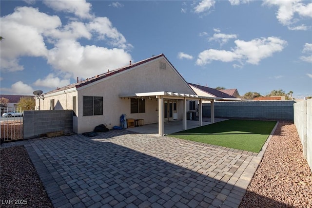 2610 Gardenia Flower Ave, North Las Vegas, NV 89031 - rear view of house featuring a fenced backyard, stucco siding, a pergola, and a patio area