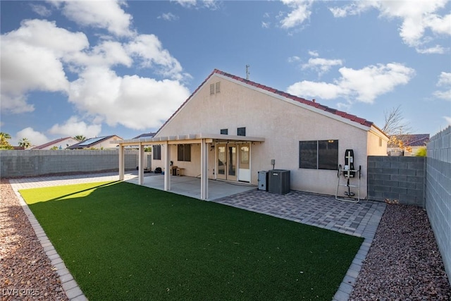 2610 Gardenia Flower Ave, North Las Vegas, NV 89031 - rear view of house with stucco siding, a fenced backyard, and a patio area