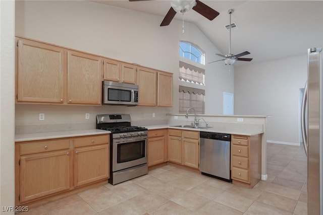 2610 Gardenia Flower Ave, North Las Vegas, NV 89031 - kitchen featuring appliances with stainless steel finishes, light brown cabinetry, a ceiling fan, a peninsula, and light countertops