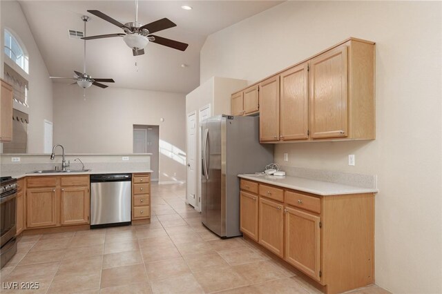 2610 Gardenia Flower Ave, North Las Vegas, NV 89031 - kitchen featuring appliances with stainless steel finishes, high vaulted ceiling, a ceiling fan, light countertops, and light brown cabinetry