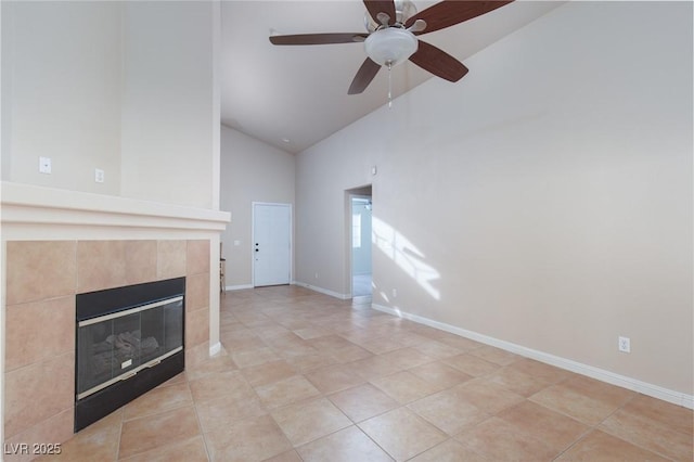 2610 Gardenia Flower Ave, North Las Vegas, NV 89031 - unfurnished living room featuring high vaulted ceiling, a tiled fireplace, ceiling fan, and light tile patterned flooring