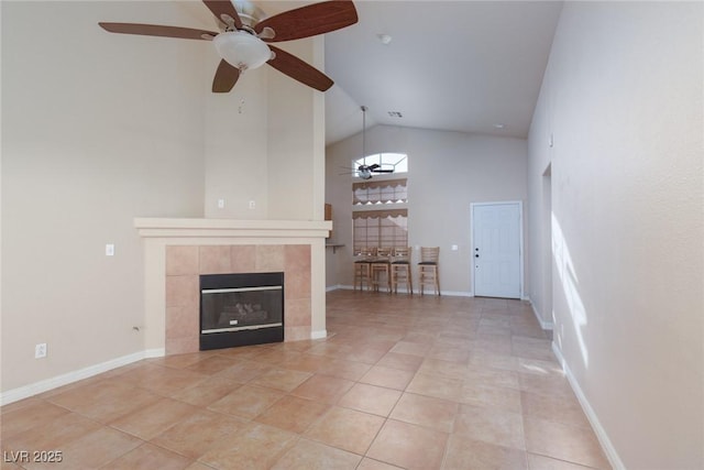 2610 Gardenia Flower Ave, North Las Vegas, NV 89031 - unfurnished living room featuring high vaulted ceiling, a ceiling fan, a fireplace, and light tile patterned flooring