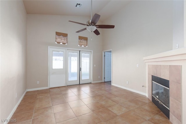 2610 Gardenia Flower Ave, North Las Vegas, NV 89031 - unfurnished living room with high vaulted ceiling, ceiling fan, a fireplace, french doors, and light tile patterned floors