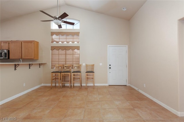 2610 Gardenia Flower Ave, North Las Vegas, NV 89031 - dining room featuring high vaulted ceiling, a ceiling fan, and light tile patterned flooring