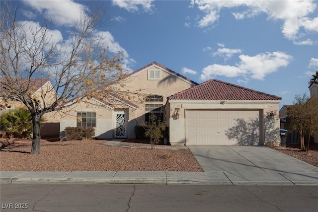 2610 Gardenia Flower Ave, North Las Vegas, NV 89031 - mediterranean / spanish house featuring stucco siding, a garage, driveway, and a tile roof