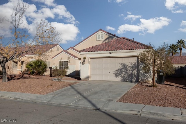 2610 Gardenia Flower Ave, North Las Vegas, NV 89031 - mediterranean / spanish-style house with an attached garage, concrete driveway, stucco siding, and a tiled roof