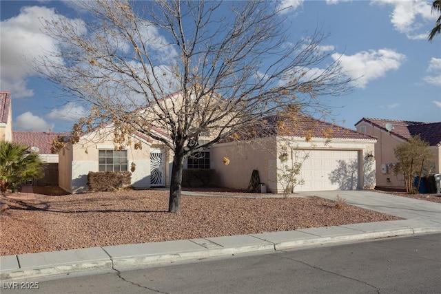 2610 Gardenia Flower Ave, North Las Vegas, NV 89031 - view of front of house featuring stucco siding, concrete driveway, and an attached garage