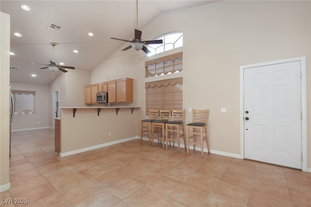 2610 Gardenia Flower Ave, North Las Vegas, NV 89031 - kitchen featuring stainless steel microwave, ceiling fan, a kitchen bar, a peninsula, and recessed lighting