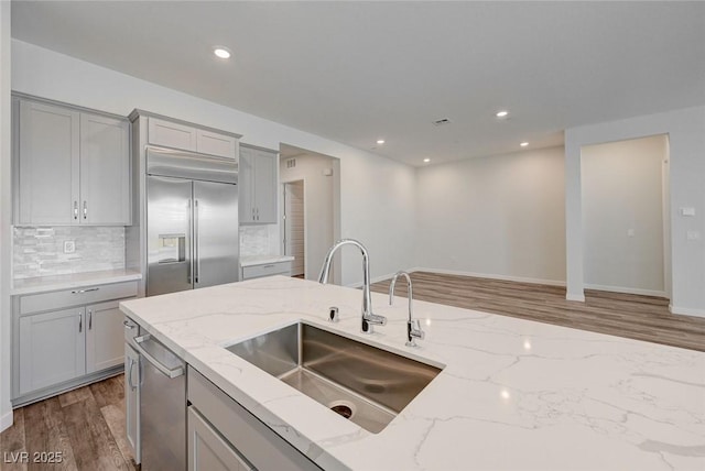 12436 Primrose Grove Ln, Las Vegas, NV 89138 - kitchen with appliances with stainless steel finishes, gray cabinetry, tasteful backsplash, light stone counters, and recessed lighting