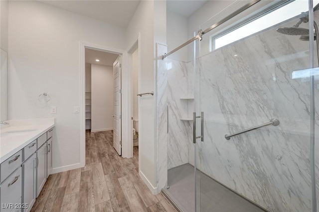 12436 Primrose Grove Ln, Las Vegas, NV 89138 - full bath featuring a marble finish shower, wood finished floors, vanity, and a walk in closet