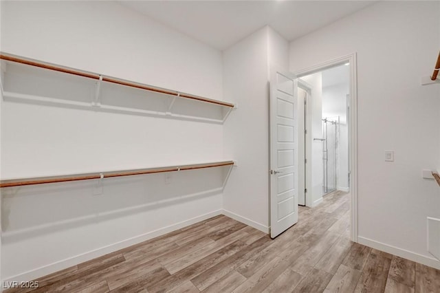 12436 Primrose Grove Ln, Las Vegas, NV 89138 - walk in closet featuring light wood-type flooring