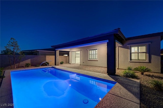 12436 Primrose Grove Ln, Las Vegas, NV 89138 - pool at twilight with a fenced backyard and a patio area