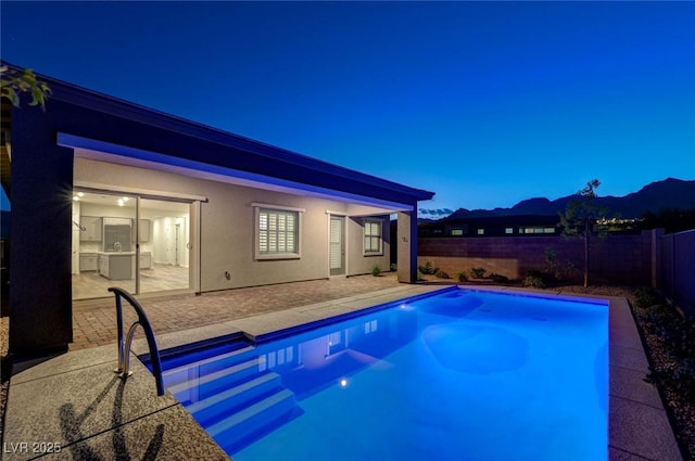 12436 Primrose Grove Ln, Las Vegas, NV 89138 - view of swimming pool featuring a patio, a fenced backyard, and a mountain view