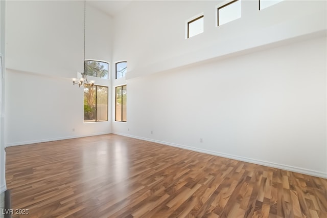 1312 Autumn Wind Way, Henderson, NV 89052 - empty room with a chandelier, a high ceiling, and wood finished floors