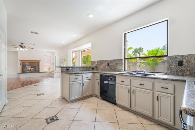 1312 Autumn Wind Way, Henderson, NV 89052 - kitchen featuring backsplash, light tile patterned floors, a peninsula, black dishwasher, and a ceiling fan