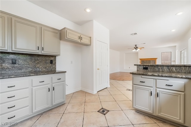 1312 Autumn Wind Way, Henderson, NV 89052 - kitchen with decorative backsplash, ceiling fan, light tile patterned floors, dark stone counters, and recessed lighting