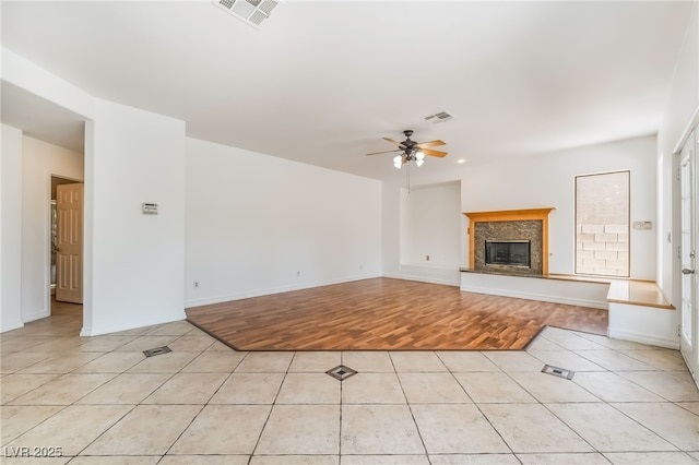 1312 Autumn Wind Way, Henderson, NV 89052 - unfurnished living room with a ceiling fan, light tile patterned floors, and a high end fireplace