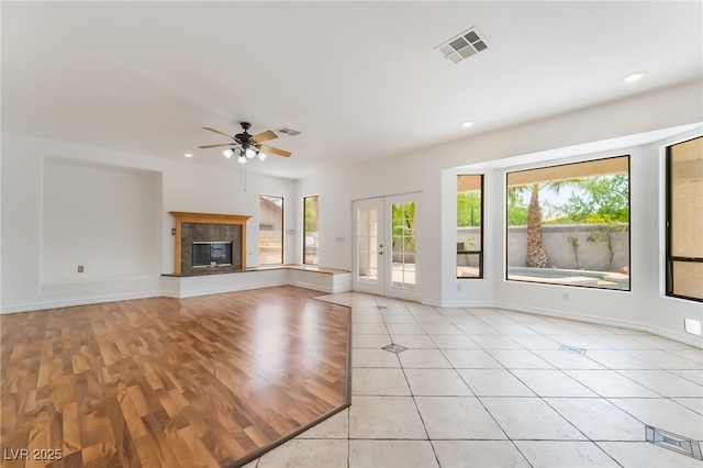 1312 Autumn Wind Way, Henderson, NV 89052 - unfurnished living room with plenty of natural light, a ceiling fan, light wood-style flooring, recessed lighting, and a premium fireplace