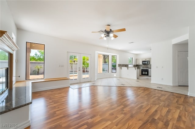 1312 Autumn Wind Way, Henderson, NV 89052 - unfurnished living room featuring a ceiling fan, light wood-style flooring, and french doors