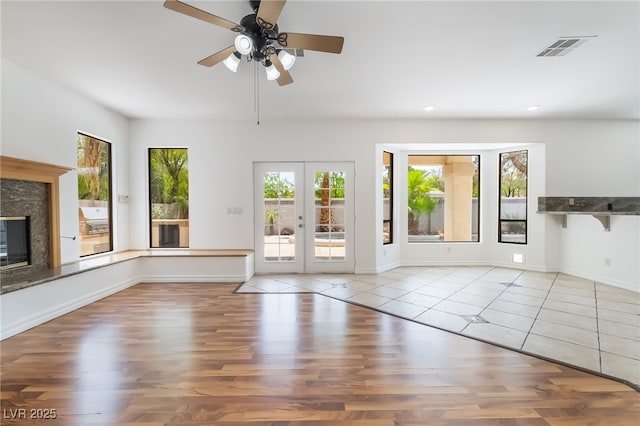 1312 Autumn Wind Way, Henderson, NV 89052 - unfurnished living room with ceiling fan, recessed lighting, wood finished floors, french doors, and a premium fireplace