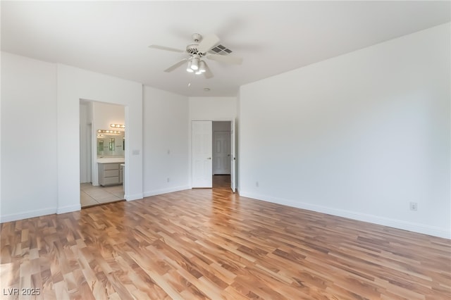 1312 Autumn Wind Way, Henderson, NV 89052 - unfurnished bedroom featuring light wood finished floors, ensuite bath, and a ceiling fan