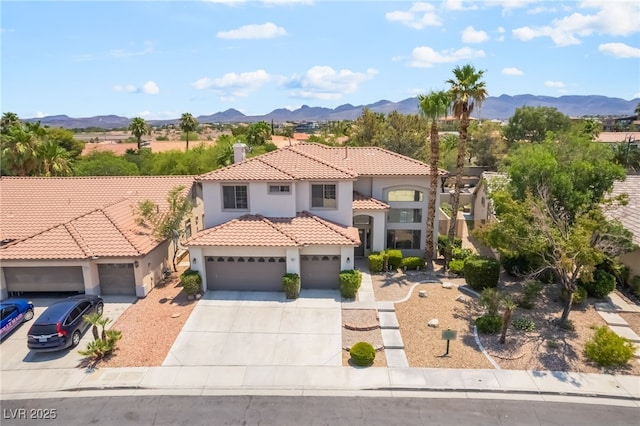 1312 Autumn Wind Way, Henderson, NV 89052 - mediterranean / spanish-style house featuring stucco siding, concrete driveway, a mountain view, and an attached garage