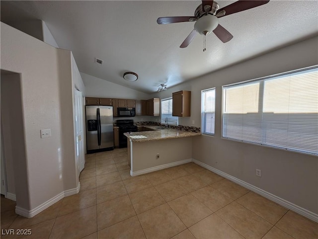 9182 Jewel Crystal Ct, Las Vegas, NV 89129 - kitchen featuring black appliances, a peninsula, light tile patterned floors, vaulted ceiling, and a ceiling fan