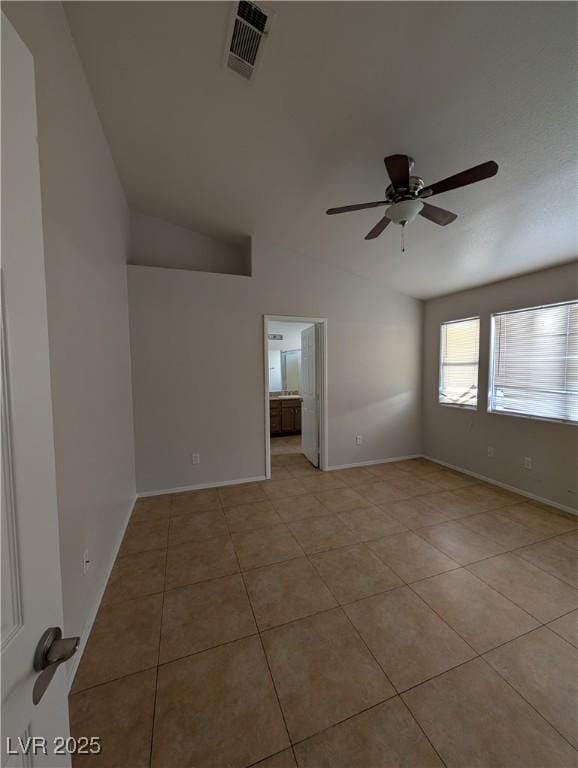 9182 Jewel Crystal Ct, Las Vegas, NV 89129 - spare room with vaulted ceiling, light tile patterned floors, and a ceiling fan