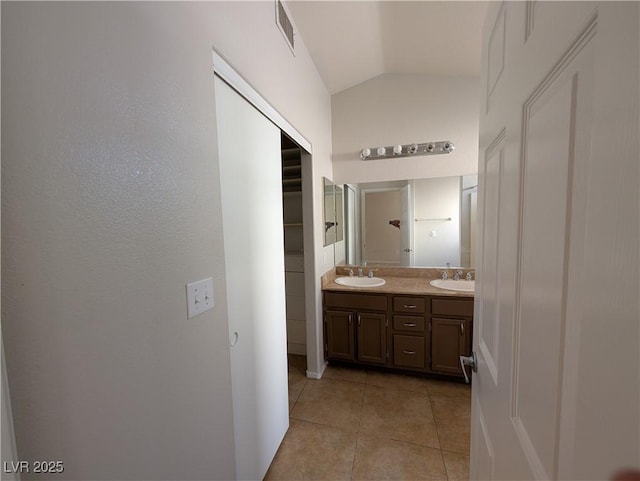 9182 Jewel Crystal Ct, Las Vegas, NV 89129 - bathroom with lofted ceiling, double vanity, and tile patterned flooring