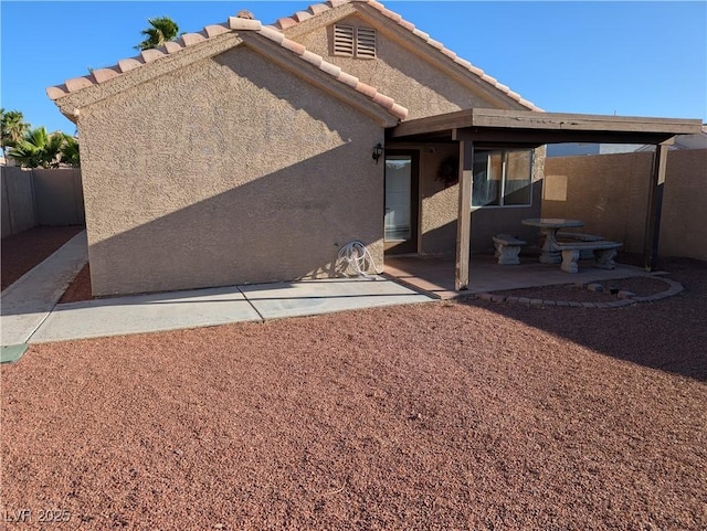 9182 Jewel Crystal Ct, Las Vegas, NV 89129 - back of house featuring a patio, stucco siding, and a tile roof