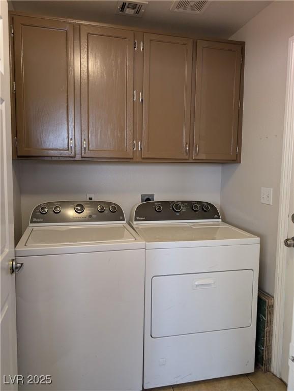 9182 Jewel Crystal Ct, Las Vegas, NV 89129 - laundry area with washer and dryer, cabinet space, and light tile patterned floors