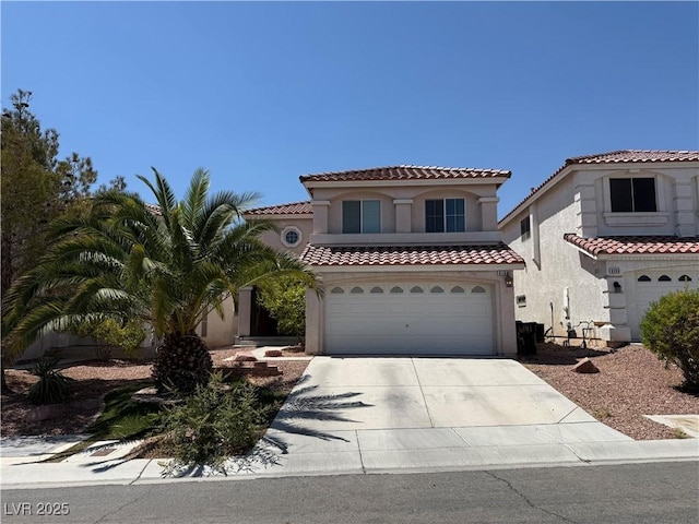 6191 Mythic Atlantis Ave, Las Vegas, NV 89139 - mediterranean / spanish house with concrete driveway, stucco siding, an attached garage, and a tile roof