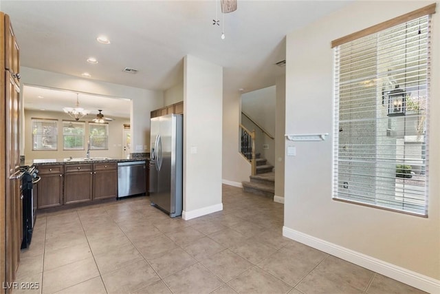 9305 Ironsend St, Las Vegas, NV 89143 - kitchen featuring stainless steel appliances, light tile patterned floors, a chandelier, recessed lighting, and decorative light fixtures