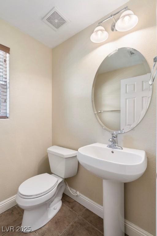 9305 Ironsend St, Las Vegas, NV 89143 - half bathroom with toilet and tile patterned floors